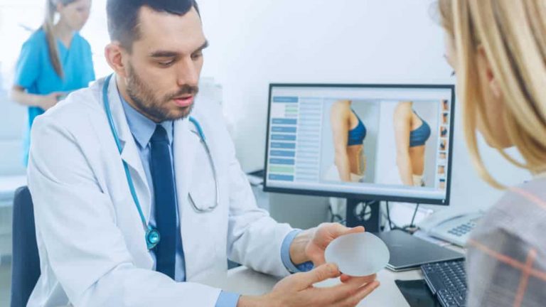 A plastic surgeon helping a woman choose the type of implants for her breast augmentation