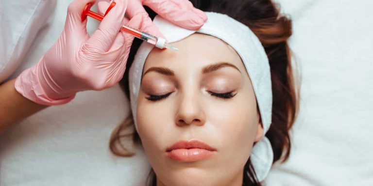 A young woman getting preventative botulinum toxin (Dysport) injections