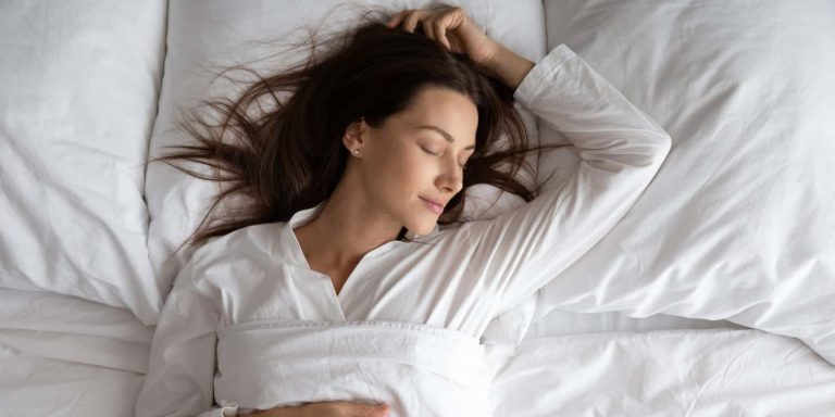 A woman sleeping after a tummy tuck